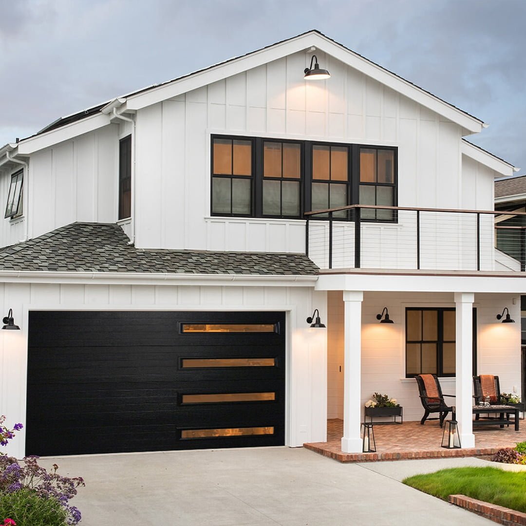 modern home with white siding and black garage door