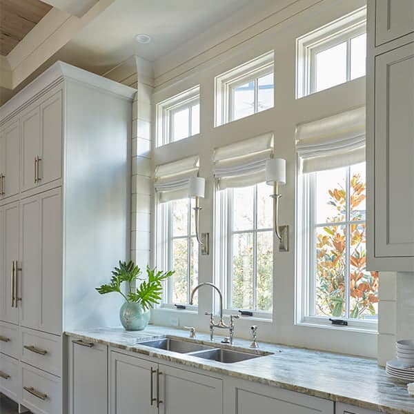 white casement windows in classic-style all-white kitchen