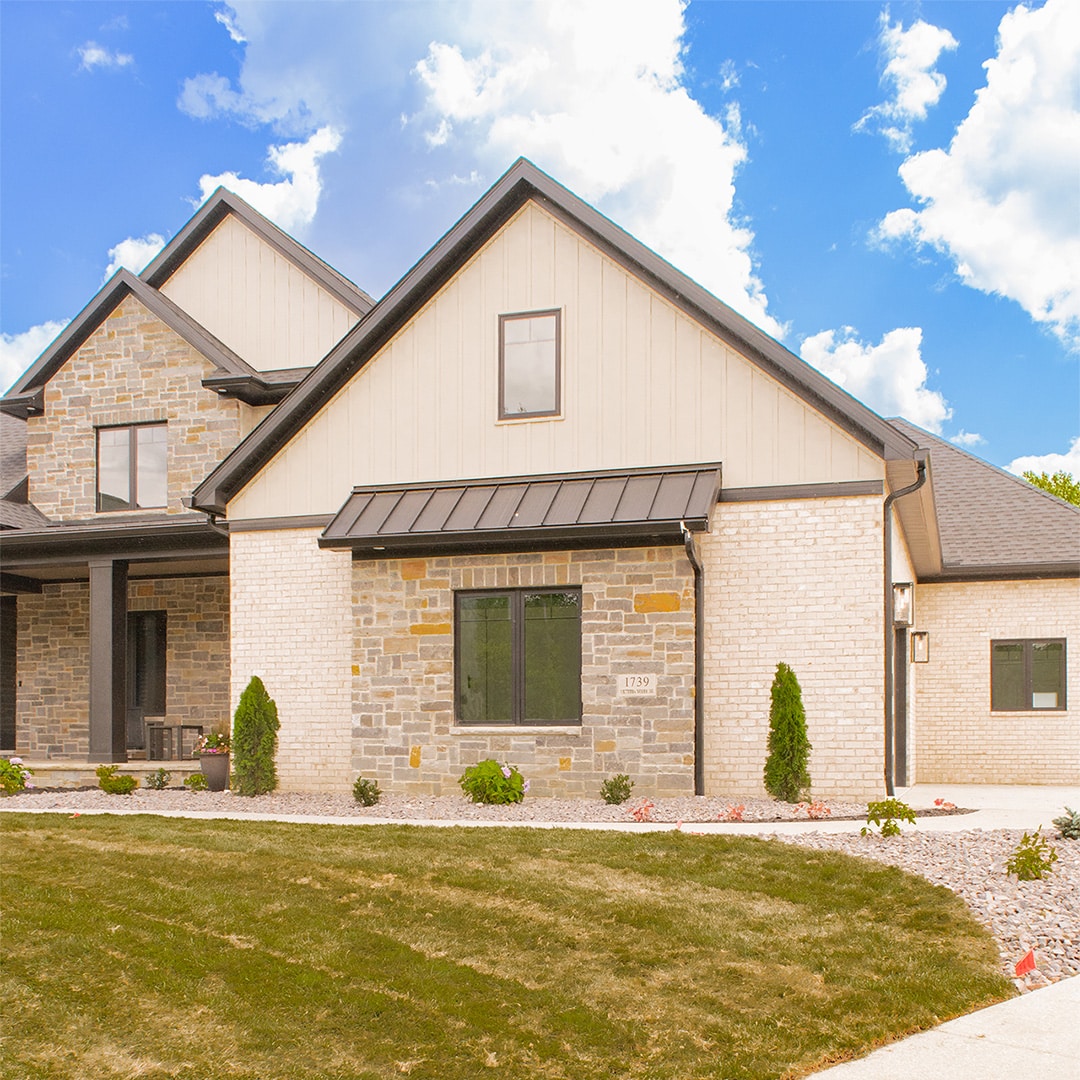 large home with vertical tan siding