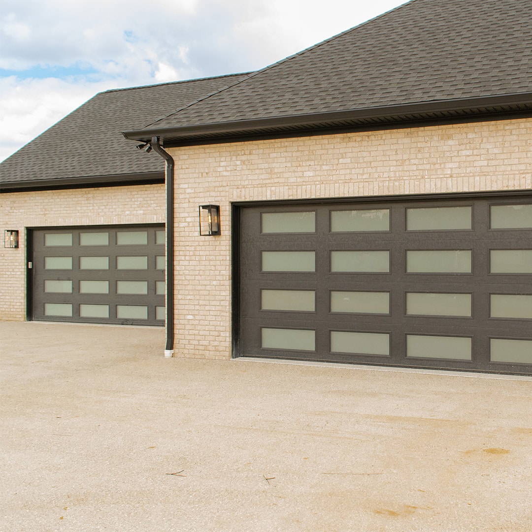 two modern garage doors on large home