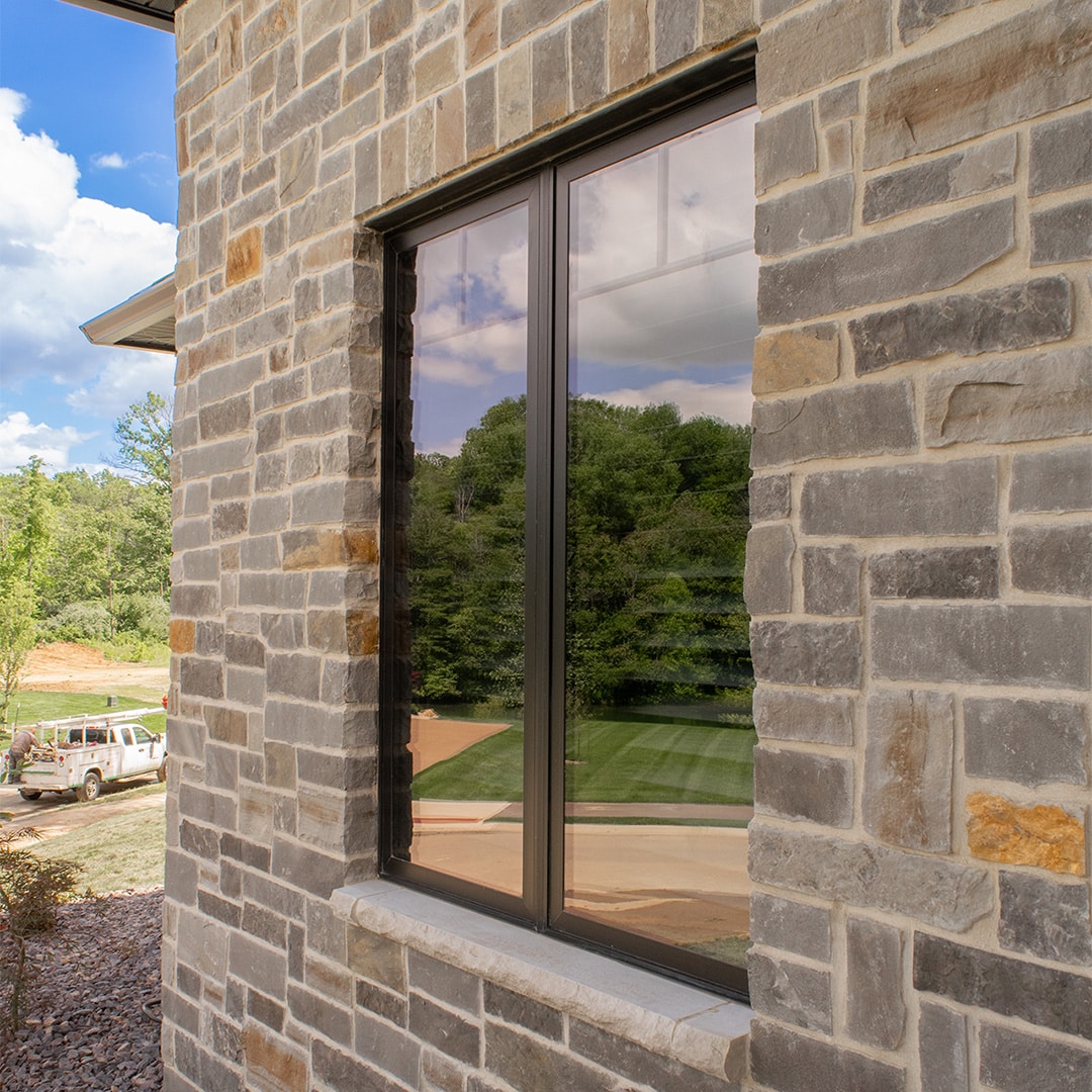 modern black window on stone exterior of home