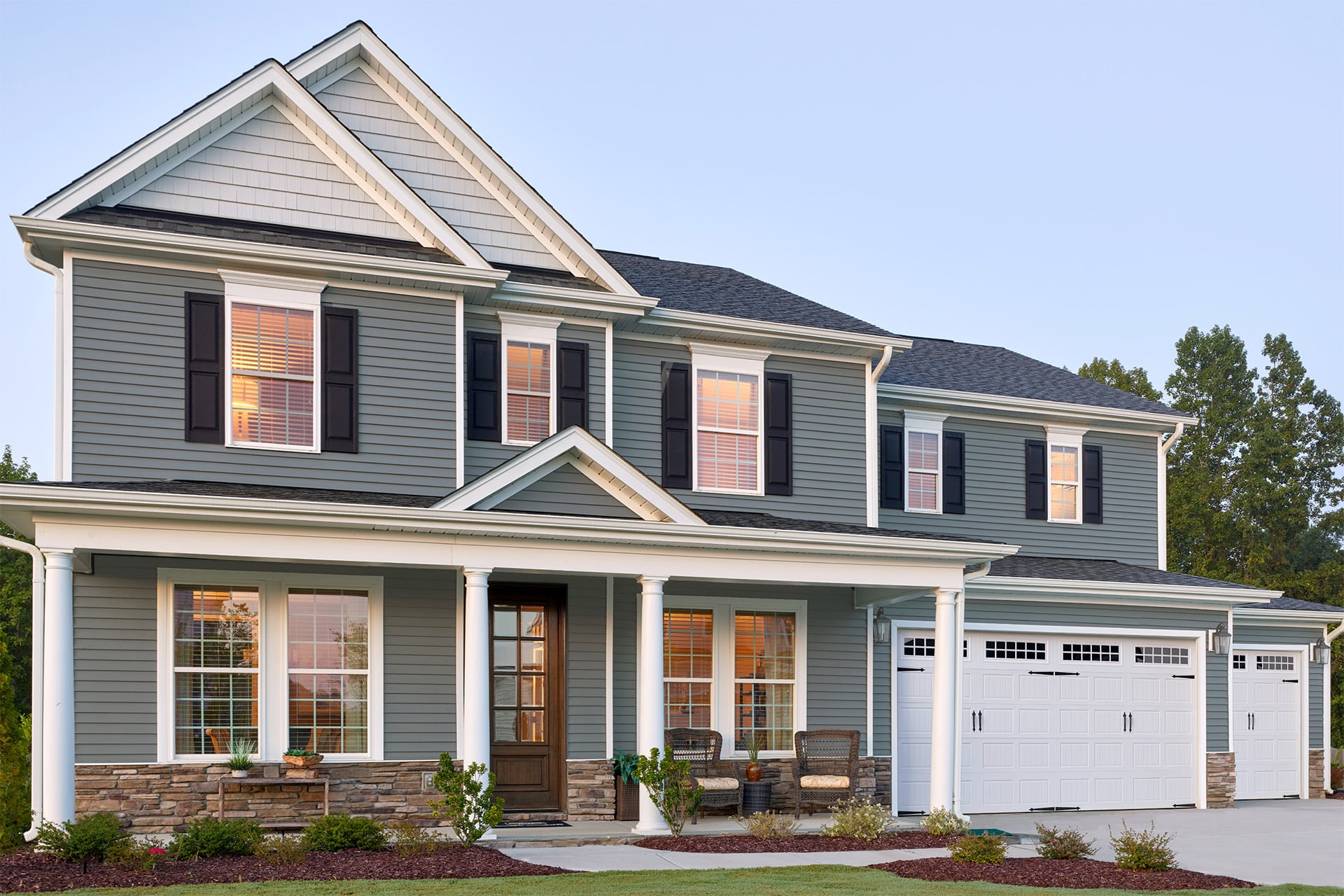 colonial-style house with blue vinyl siding