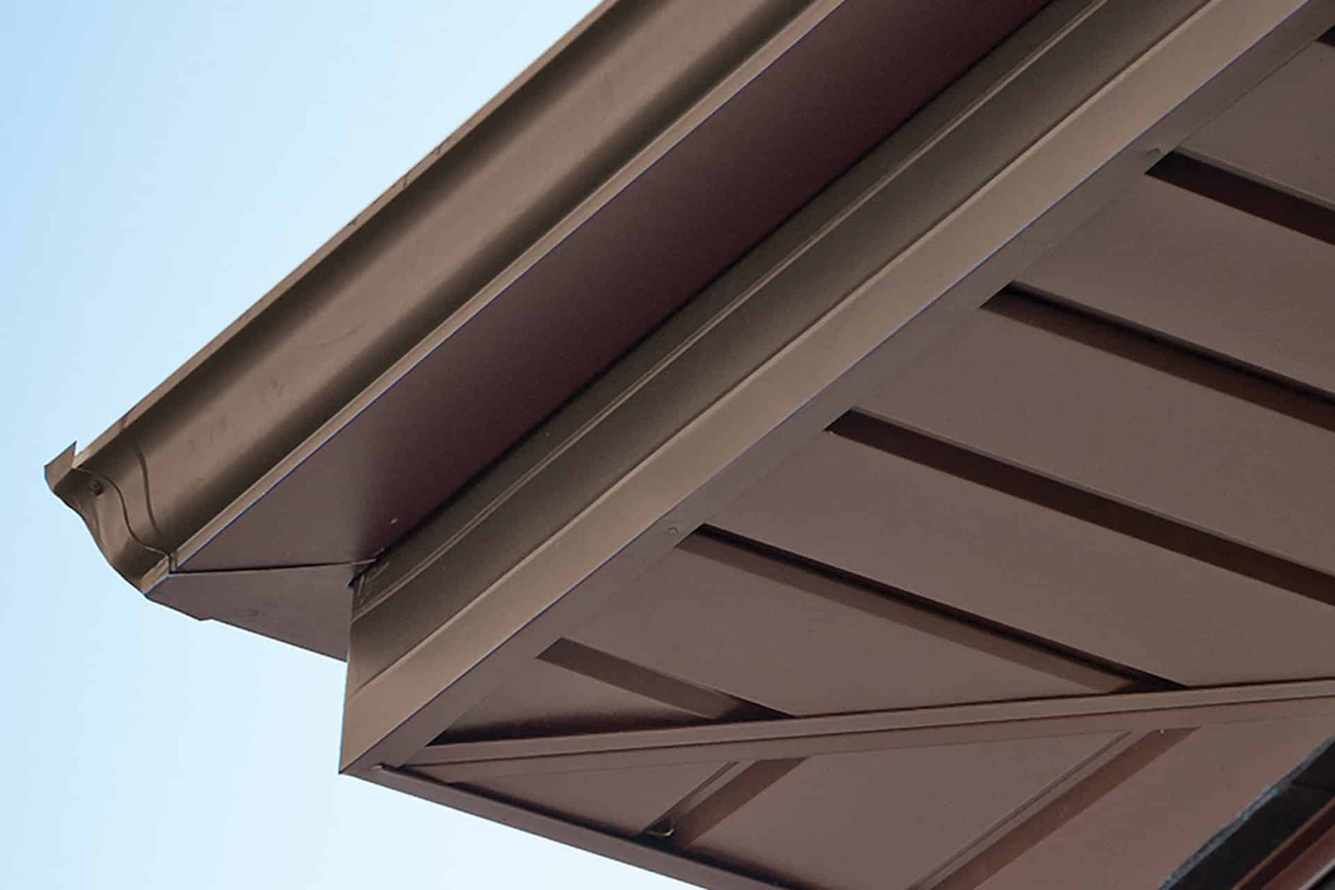 brown gutter, coil stock and soffit on home