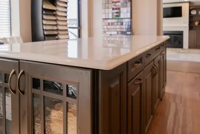 kitchen island with dark wood stain and quartz countertop