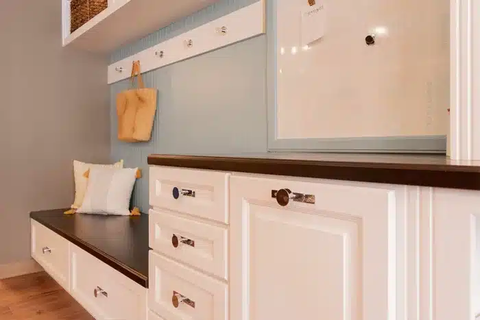 white cabinets with chrome finishes and wood top