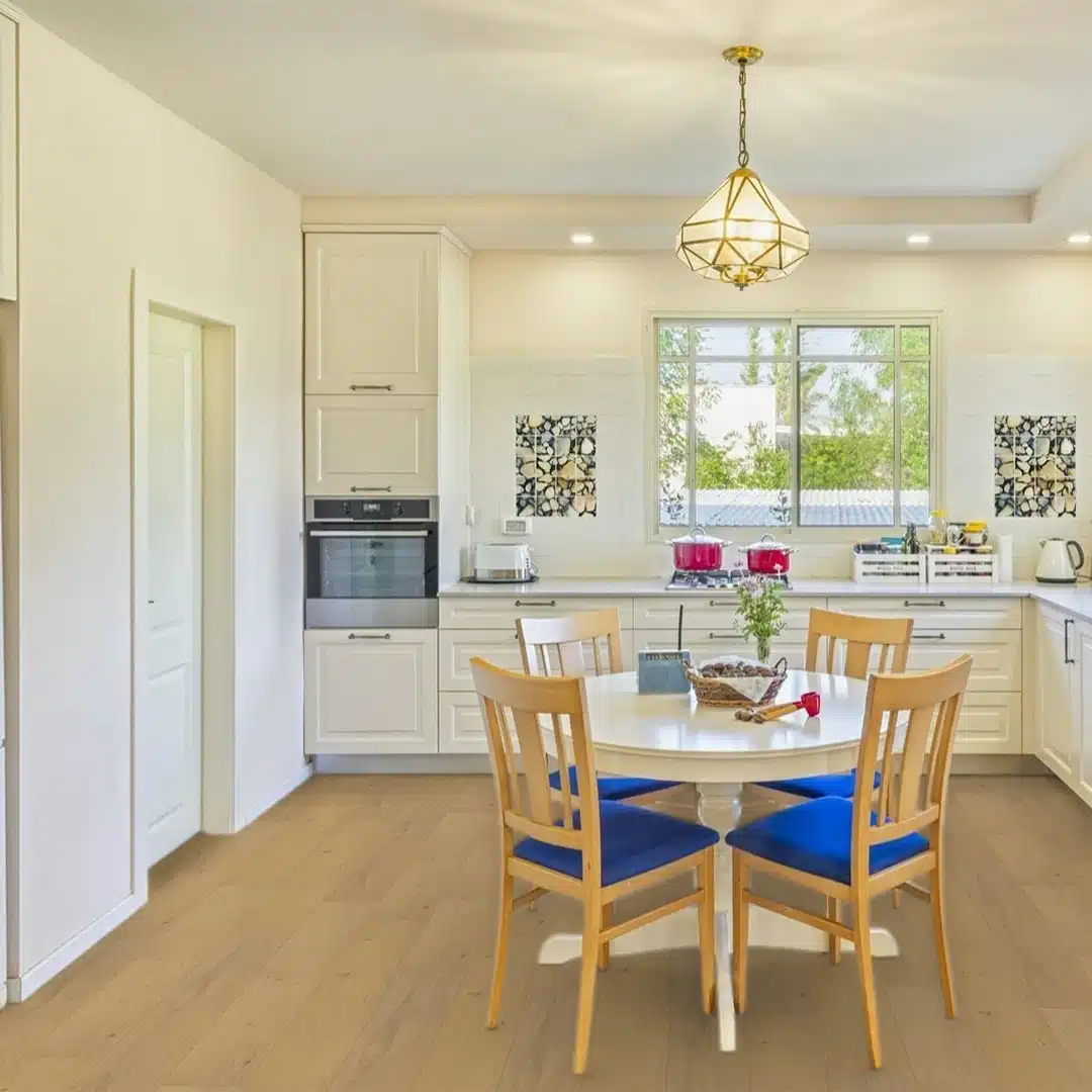 kitchen with white cabinets light colored wood floors