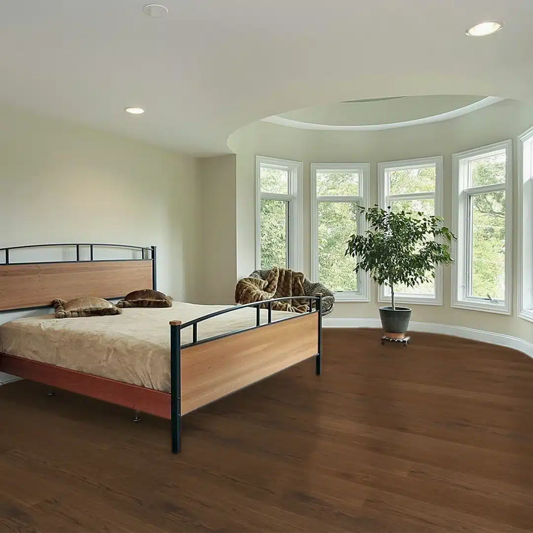 bedroom with bed, plant, chair and wood flooring