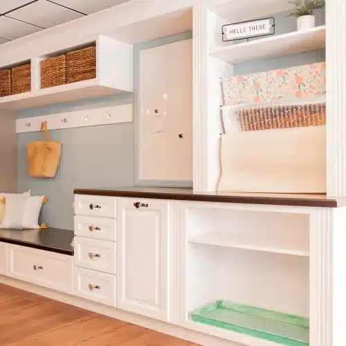 white built-in cabinet storage and bench