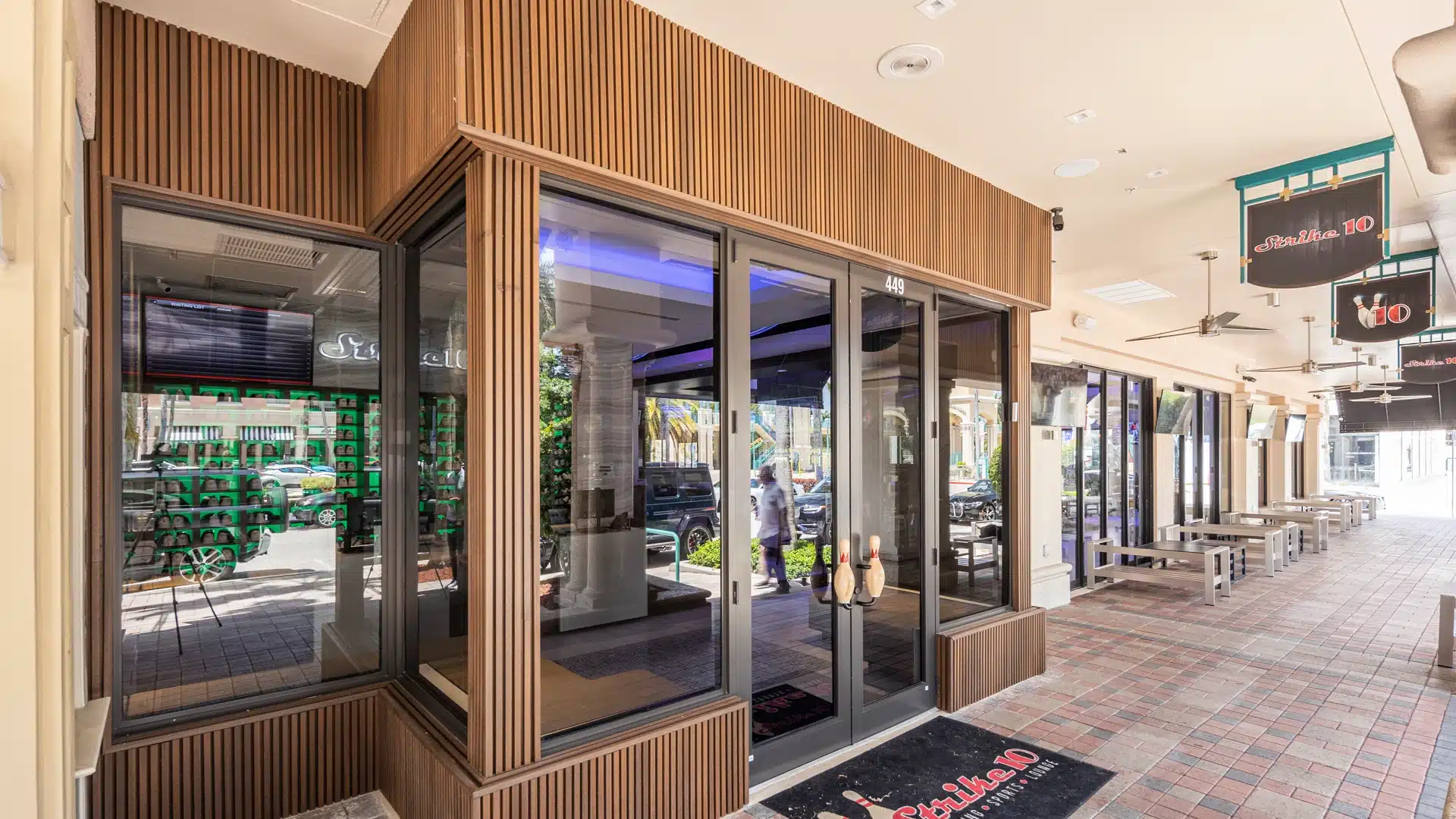 bowling alley entrance with brown wood composite cladding