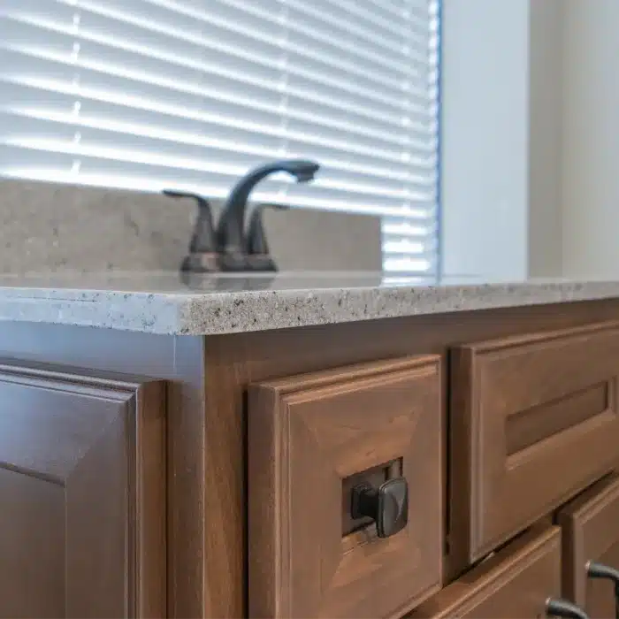 stained poplar vanity cabinet with matte black finishes