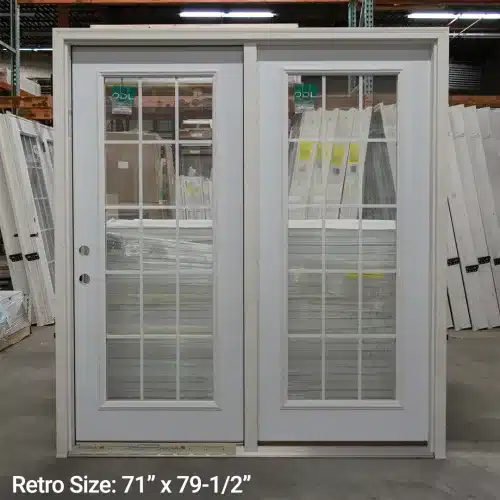 white patio doors standing inside warehouse