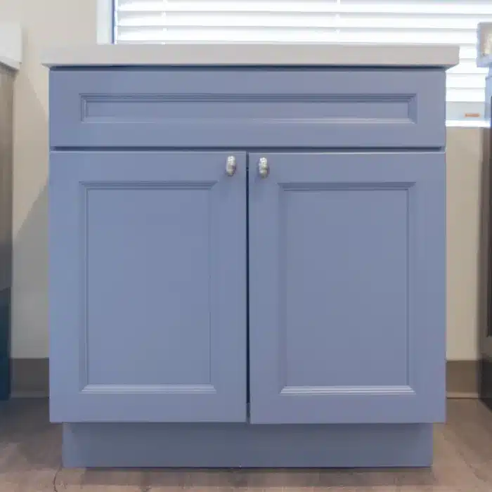 blue vanity cabinet with silver finishes and two doors