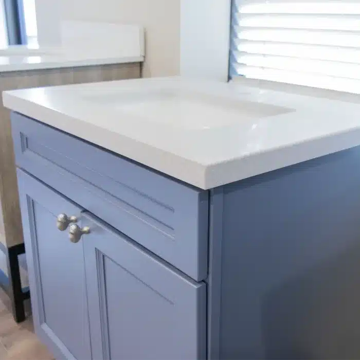 light blue vanity cabinet with silver finishes