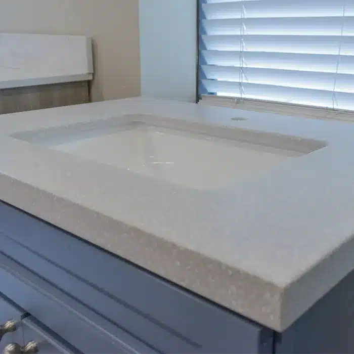 light cultured marble top on blue vanity cabinet