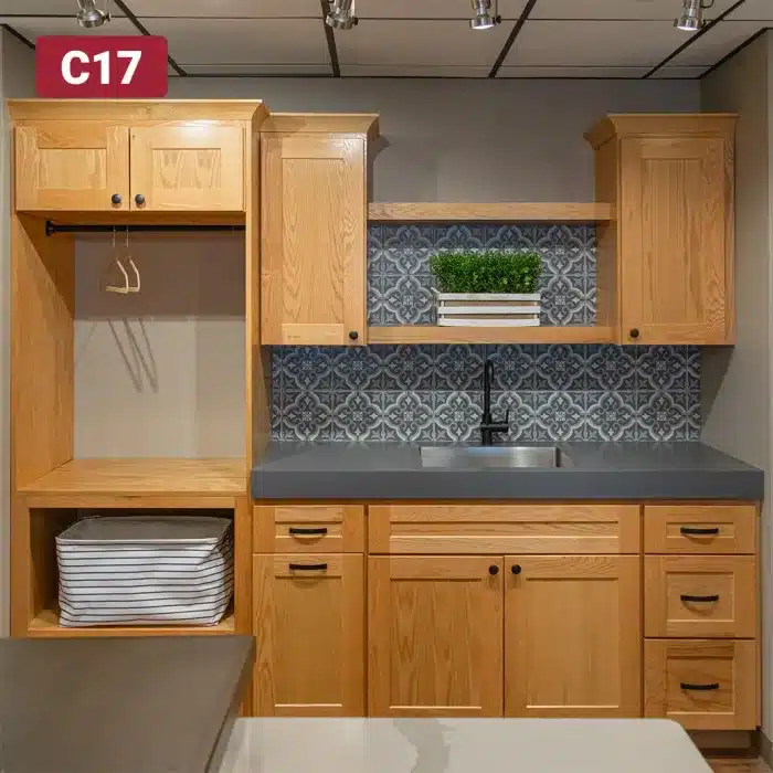 laundry room cabinetry with light stain and dark countertop