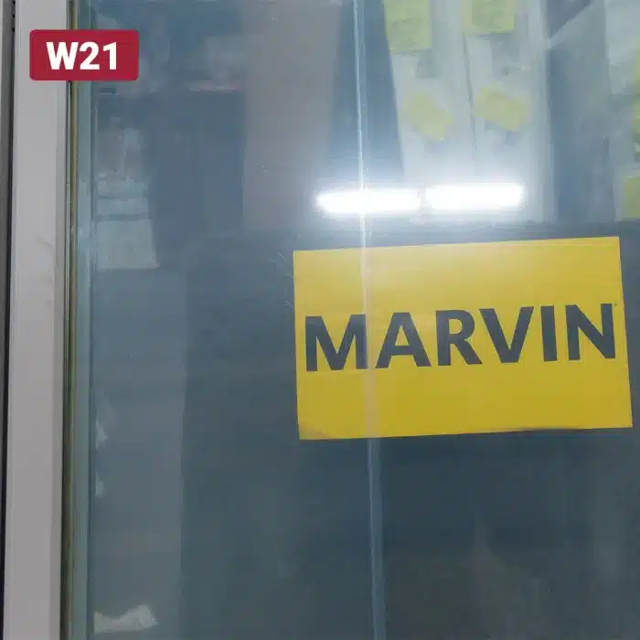 yellow marvin manufacturer sticker on window glass pane