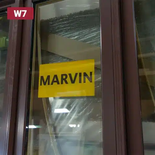 yellow marvin sticker on glass window pane